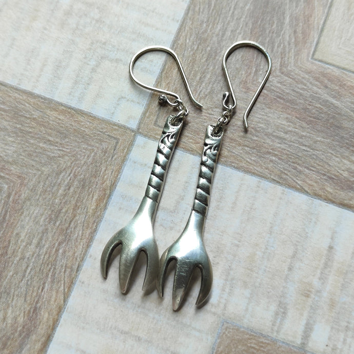 Pair of sterling silver earrings made from the claw ends of vintage sugar tongs, featuring detailed handles and hook-style ear wires