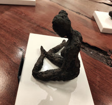 Load image into Gallery viewer, Original mixed media sculpture titled The Responder, showing a seated figure on a white base with a dark textured finish.