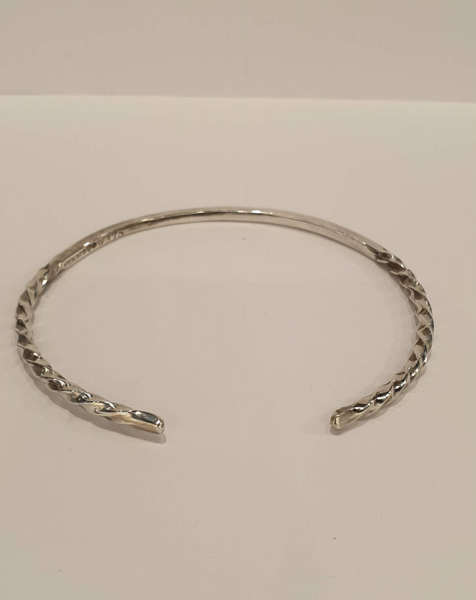 A silver bangle with twisted  ends